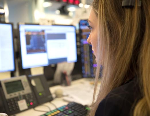 Woman looking at monitors