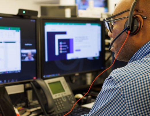 man in headphones looking at computer