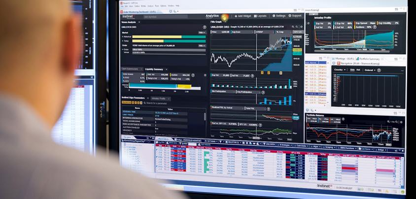 Person looking at graphs on monitor