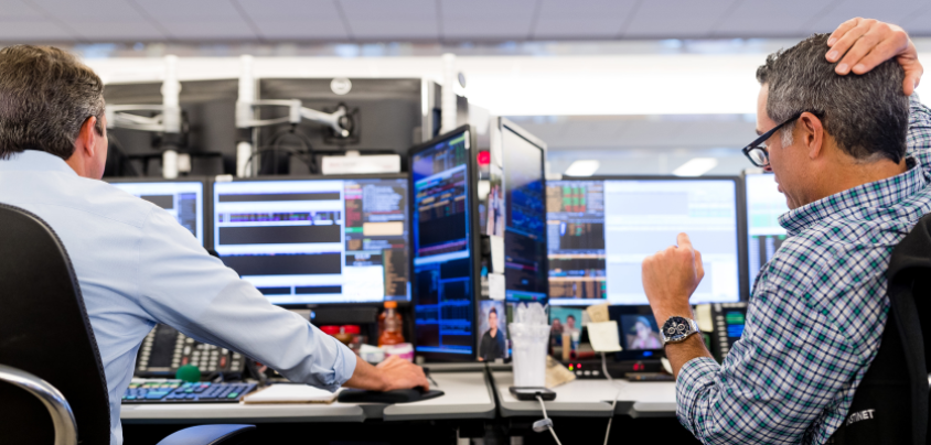 two men looking at computers